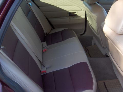 2004 Ford Crown Victoria - The interior of a car with two-tone seats and door panels is visible.