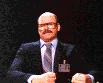 1991 Ford LTD Crown Victoria - A man in formal attire with glasses and a mustache is visible against a dark background.