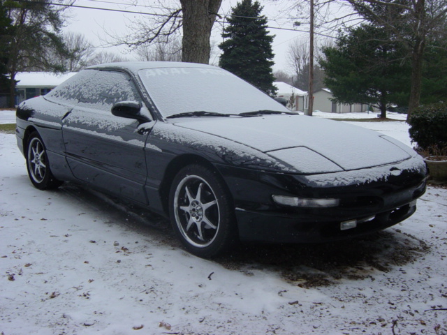Black 1995 Ford Probe in snow, 3q front view