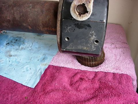 1987 Ford Bronco - A driveshaft component with visible splines and a part number is shown on towels.