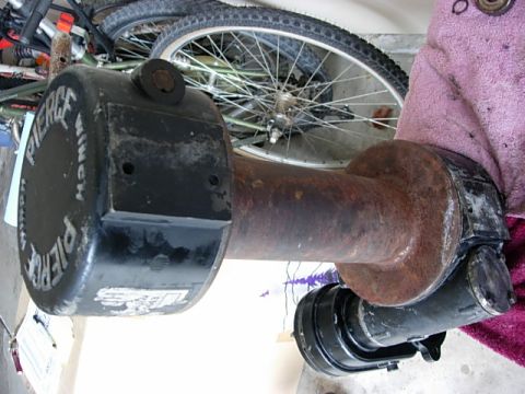 1987 Ford Bronco - A close-up view of a rusty winch drum, identified by text on its black end cap.