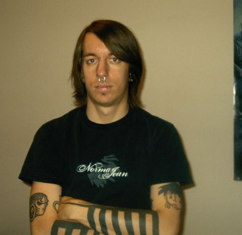 1992 Ford Probe - A man with multiple tattoos and piercings poses for a photo, wearing a black t-shirt.