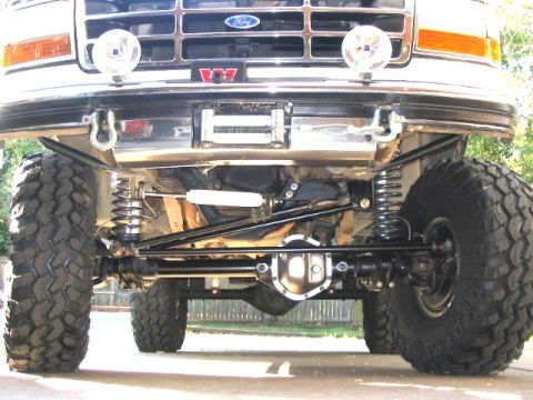 1995 Ford Bronco - This modified Ford truck features an upgraded suspension system and a winch mounted on the front bumper.