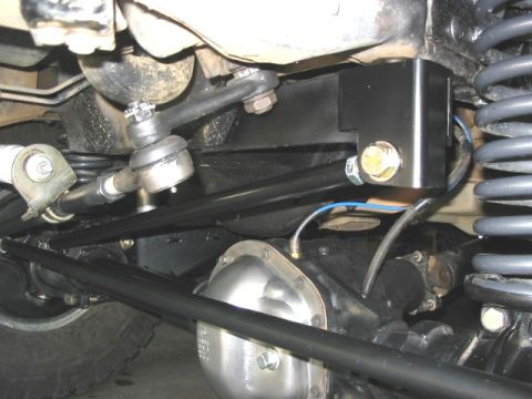 1995 Ford Bronco - Undercarriage view shows steering components and suspension parts of an off-road vehicle.