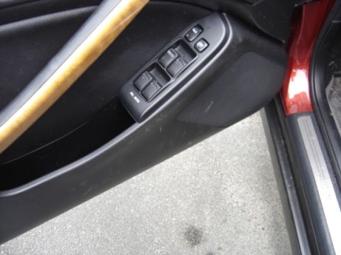 1999 Ford Taurus - Close-up of a car's interior door panel, showing the window controls and speaker.