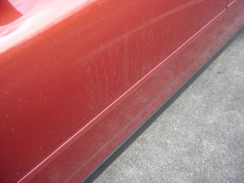 1999 Ford Taurus - Dusty red car door panel with black trim.