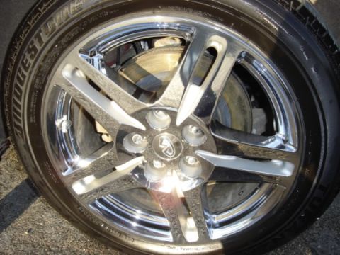 1999 Ford Taurus - Close-up of a chrome wheel and Bridgestone tire, a distinctive center cap logo.