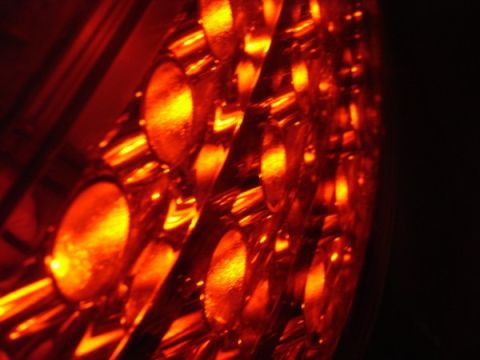 1999 Ford Taurus - The intricate pattern of a vehicle's illuminated taillight is captured in this close-up shot.