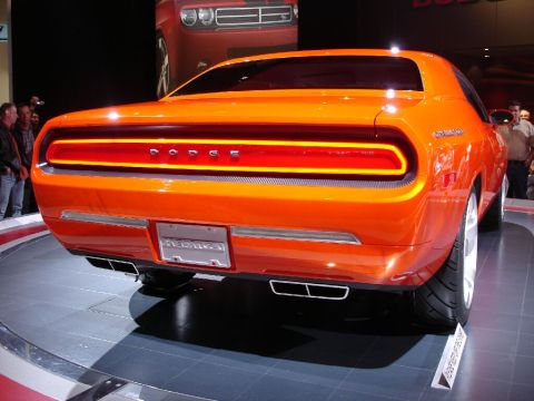 1986 Ford Bronco - Rear view of an orange Dodge Challenger concept car on display, with another Dodge vehicle visible in the background.