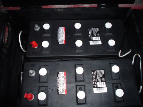 1966 International School Bus - Two large batteries are visible within a compartment, likely for a vehicle's electrical system.