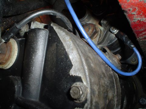 1966 International School Bus - Close-up view of a vehicle's starter motor and associated wiring, highlighting mechanical components.
