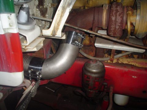 1966 International School Bus - Close-up view of engine components, including a turbocharger and exhaust piping.
