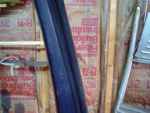 1984 Ford Bronco - Interior view of a wall with insulation, pipes, and a ladder, not a 1984 Ford Bronco.