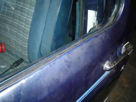 1984 Ford Bronco - Interior view of a 1984 Ford Bronco, showing the patterned seat fabric and exterior door handle.