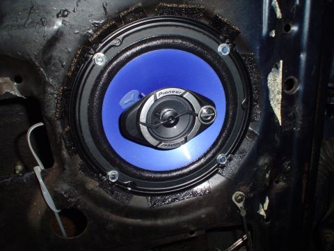 1984 Ford Bronco - Close-up of a Pioneer speaker mounted in a vehicle's door, showing wiring and mounting hardware.