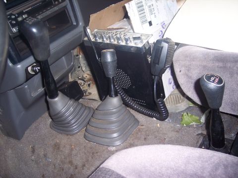 1995 Toyota Tacoma - Vehicle interior with multiple shifters and a CB radio visible.