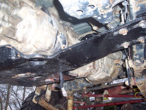 1995 Toyota Tacoma - Close-up of the underside of a vehicle, focusing on the drivetrain and suspension parts.