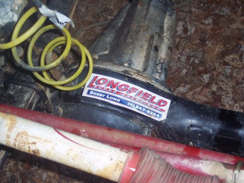 1995 Toyota Tacoma - Close-up of a differential housing with a "Longfield Super Axles" sticker and a yellow hose.
