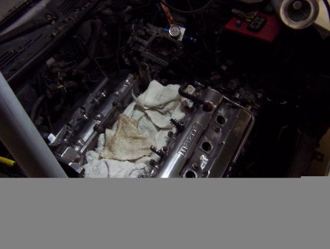 1993 Ford Probe - Close-up view of a Mazda engine bay, showing a chrome valve cover and surrounding components.