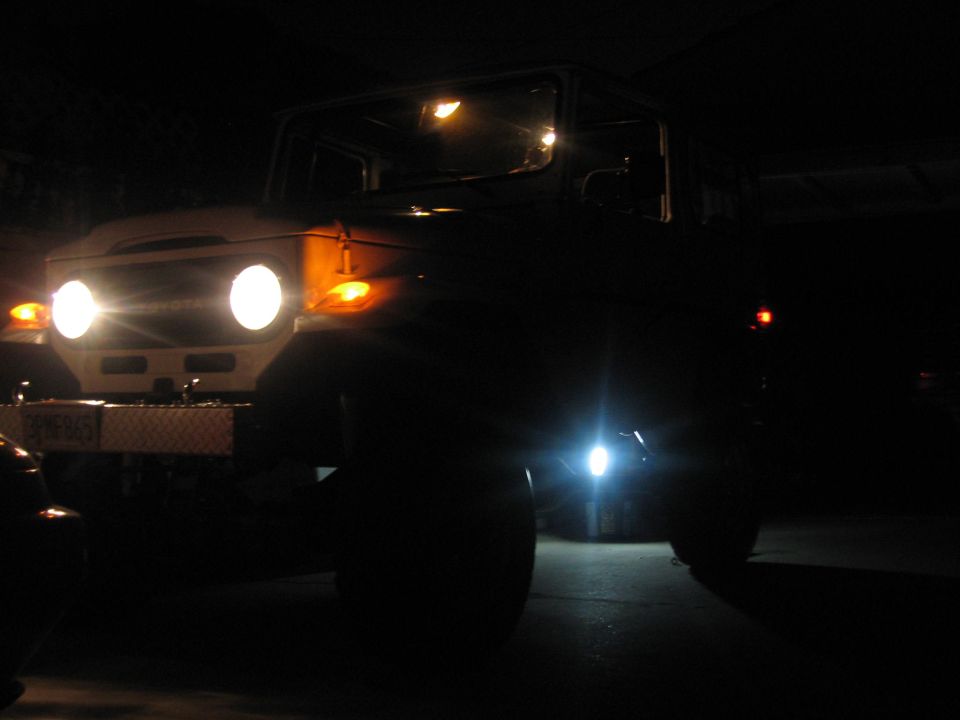 1977 Toyota Land Cruiser front view at night, headlights and parking lights on