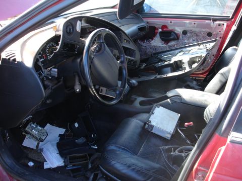 1993 Ford Taurus - The interior of a 1993 Ford Taurus shows a disassembled dashboard and black leather seats, indicating it is part of a swap.