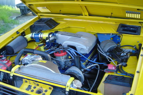 1972 Ford Bronco - Engine bay of a 1972 Ford Bronco, a V8 engine with an aftermarket intake system.