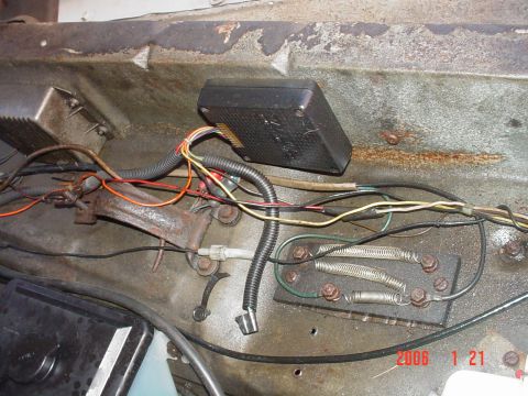 1978 Ford Bronco - The engine bay shows a complex network of wires and electrical components, with some signs of rust and wear.