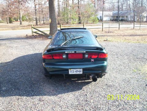 1997 Ford Probe - Rear view of a 1997 Ford Probe, showing its spoiler and custom exhaust pipe.