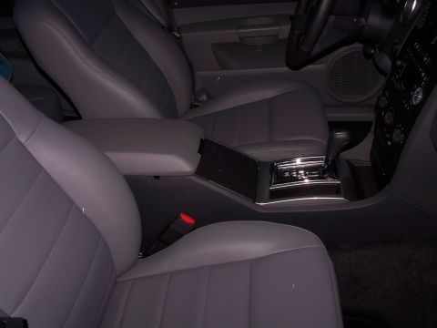 1979 Ford F-150 - Interior view of a vehicle's center console, gray leather seats and automatic transmission shifter.