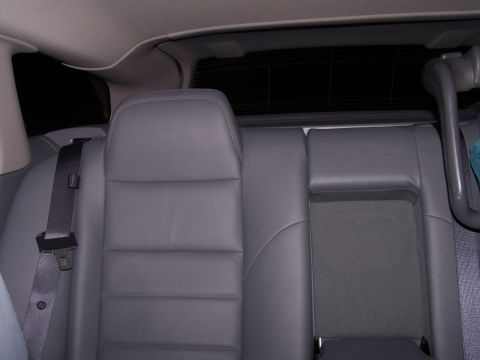 1979 Ford F-150 - Interior view of the back seats of a vehicle, showing gray upholstery and a seatbelt.