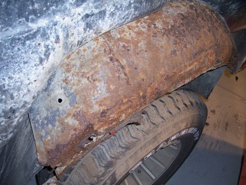 1978 Ford Bronco - The wheel well and tire of a 1978 Ford Bronco show significant rust damage.