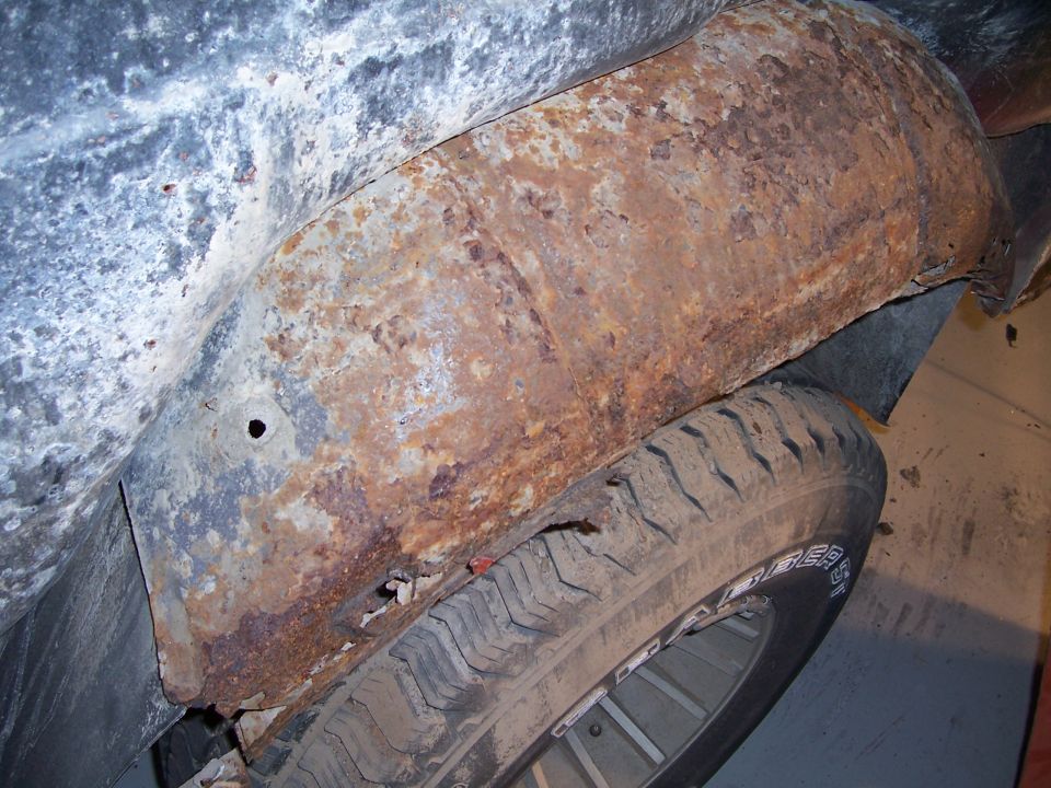 Rusted wheel well and tire of a 1978 Ford Bronco