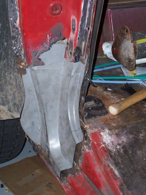 1978 Ford Bronco - Door jamb repair on a red vehicle, showing rust and a newly fitted metal section.