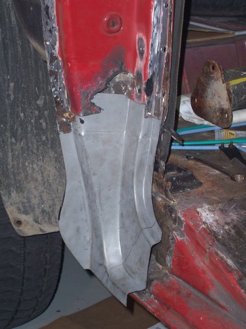 1978 Ford Bronco - This photo shows a section of a vehicle's quarter panel undergoing repair, with rusted areas replaced by new metal.