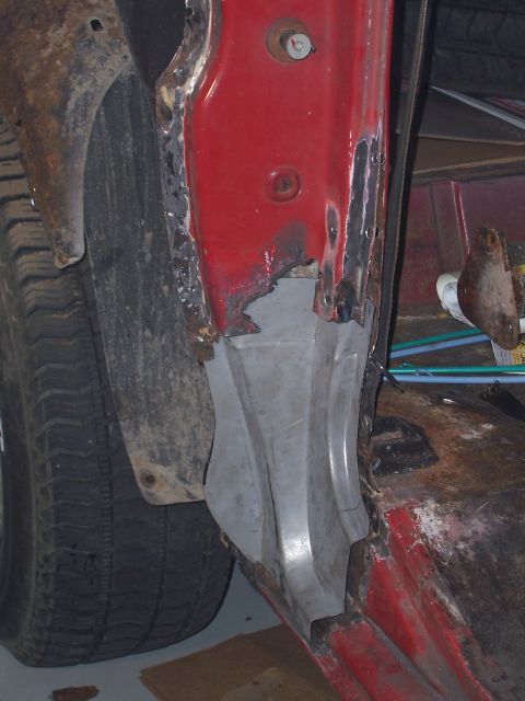 1978 Ford Bronco - This image shows a heavily rusted vehicle quarter panel and tire, indicating significant wear and repair.