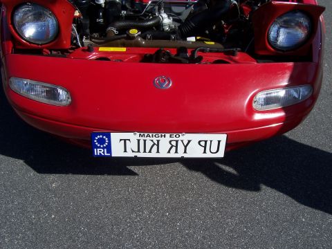 1994 Ford Probe - Front view of a red Mazda Miata with the hood open, revealing the engine bay.