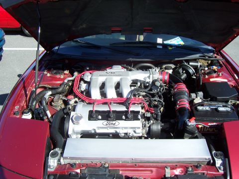 1994 Ford Probe - Close-up view of a Ford V6 engine with the hood open, showing various components and wiring.