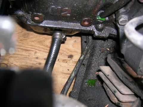 1992 Nissan 240SX - Close-up of an engine component showing a hose connection and a leak of green fluid.