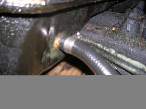 1992 Nissan 240SX - A hose and fitting connection, likely from an engine bay, showing signs of grease and wear.