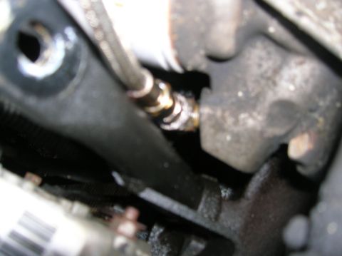 1992 Nissan 240SX - A close-up view of a hose fitting on an engine part, with some white residue visible.