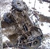 1992 Ford Bronco - This vehicle appears to be stuck in a muddy and snowy environment, overturned.