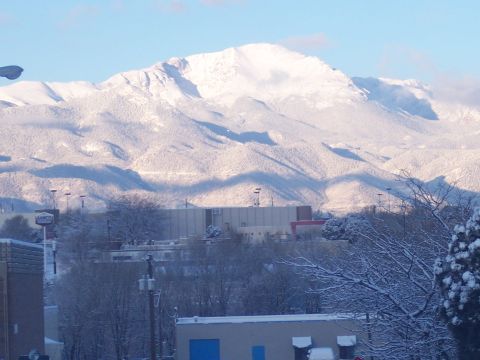 1972 Ford Ranchero - A winter scene shows snow-capped mountains in the background with buildings and trees in the foreground.