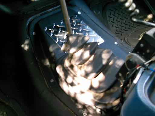 Transfer case shifter boot and diamond plate trim inside a vehicle