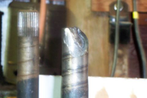 1977 Ford F-150 - Close-up of a damaged metal part, possibly a driveshaft or axle, showing splines and a chipped end.