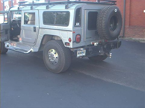 1986 Ford Bronco - This Hummer H1 is viewed from its rear-right quarter, showing its spare tire and roof rack.
