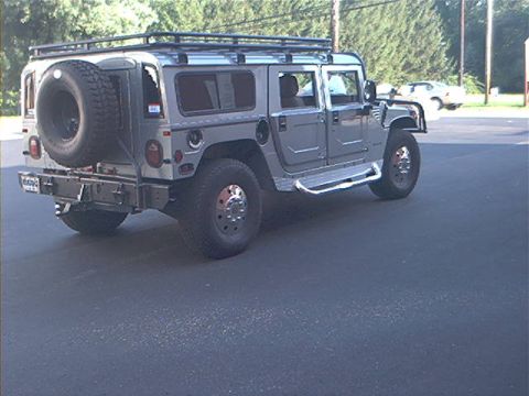 1986 Ford Bronco - This Hummer H1 features an external spare tire mounted on the rear and a roof rack for extra storage.