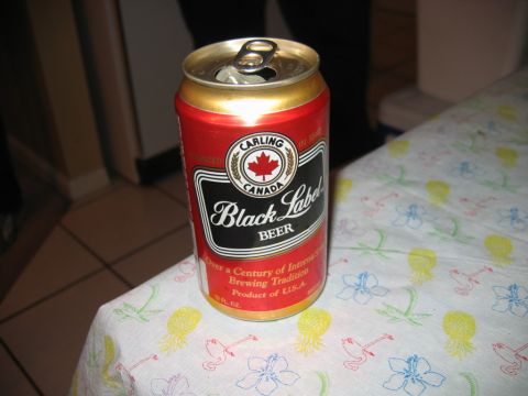 1985 Ford LTD Crown Victoria - A can of Carling Black Label Beer sits open on a tablecloth adorned with tropical motifs.