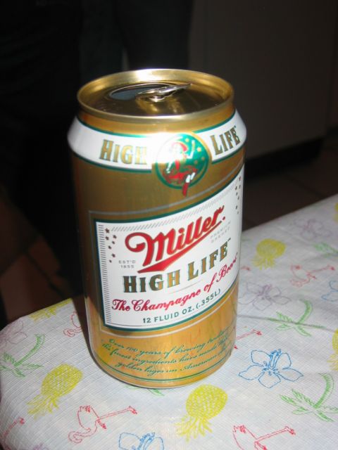 1985 Ford LTD Crown Victoria - A Miller High Life beer can sits on a tablecloth with a tropical print.