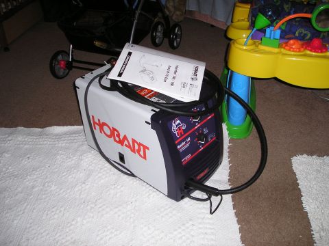 1986 Ford Bronco II - Hobart Handler 140/180 welder shown with its instruction manual and cables.
