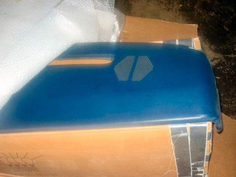 1985 Ford LTD Crown Victoria - A blue automotive part, possibly a fender or door panel, is shown in packaging within a cardboard box.